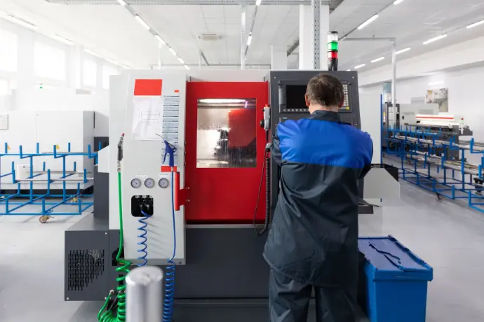 Factory engineer working on a metal processing equipment